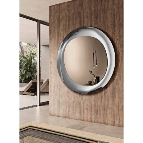 Luxor round mirror displayed on wooden wall paneling OIKADE