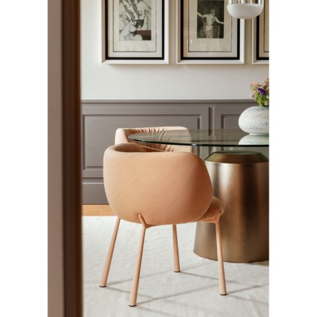 The Mys dining chair by Midj features a curved silhouette and a comfortable upholstered seat