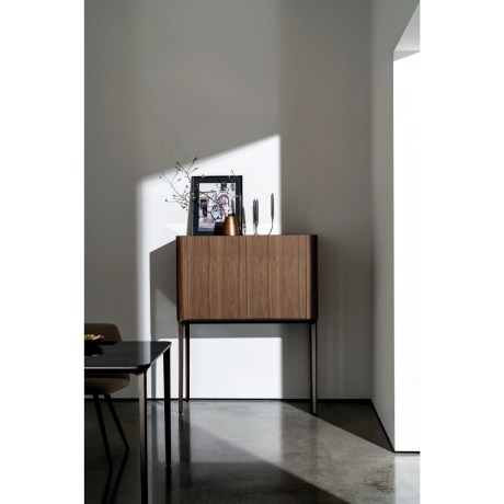 Minimalistic design highboard Slim with curved edges and high metal base, made in walnut wood finish by Sovet Italia